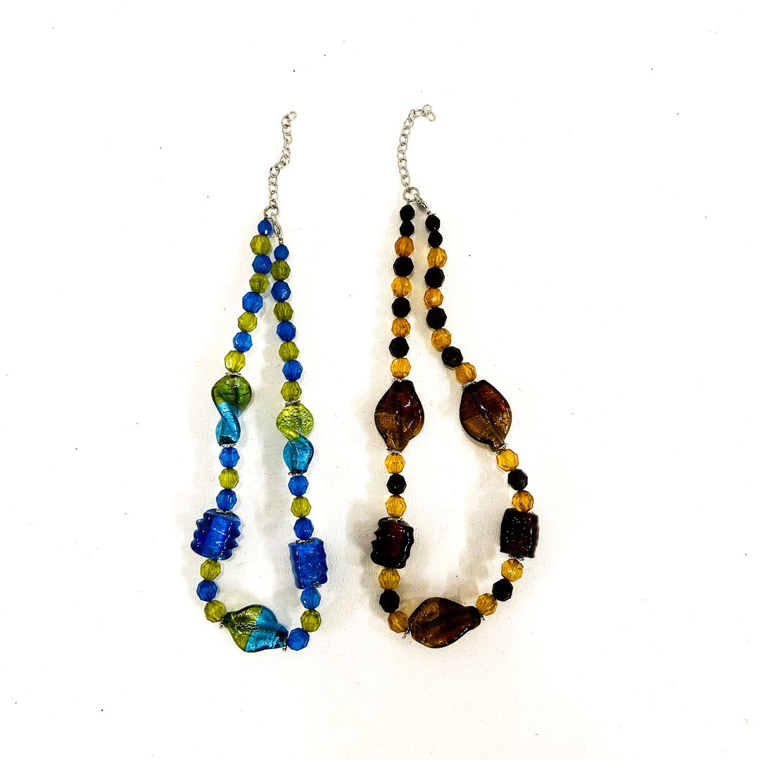 Two glass beaded necklaces on a white background